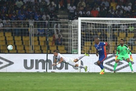 Mumbai City FC's Lucian Goian of dives to clear the ball during their ISL match against FC Goa in Margoa on Wednesday
