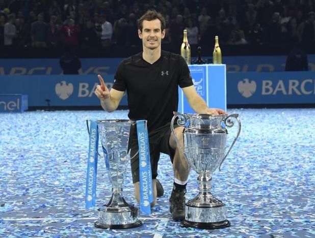 Great Britain's Andy Murray celebrates winning the final against Serbia's Novak Djokovic with the ATP World Tour Finals trophy on November 21, 2016