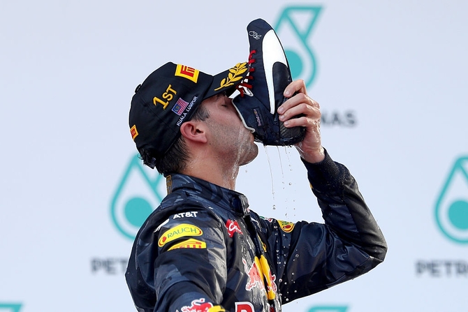 Red Bull Racing's Australian driver Daniel Ricciardo celebrates his podium finishes in his signature style -- 'The Shoey'