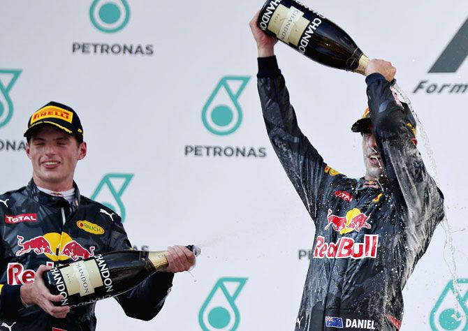 Daniel Ricciardo of Australia and Red Bull Racing and Max Verstappen of Netherlands and Red Bull Racing celebrate on the podium after the Malaysian GP