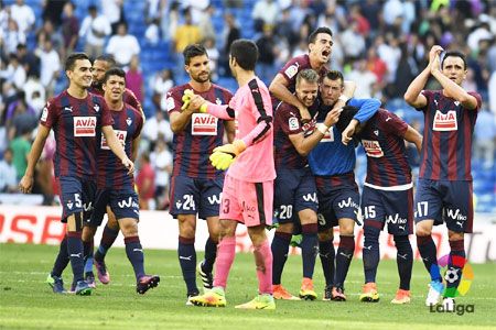 Eibar players celebrate after holding Real Madrid to a draw in their La Liga match on Sunday