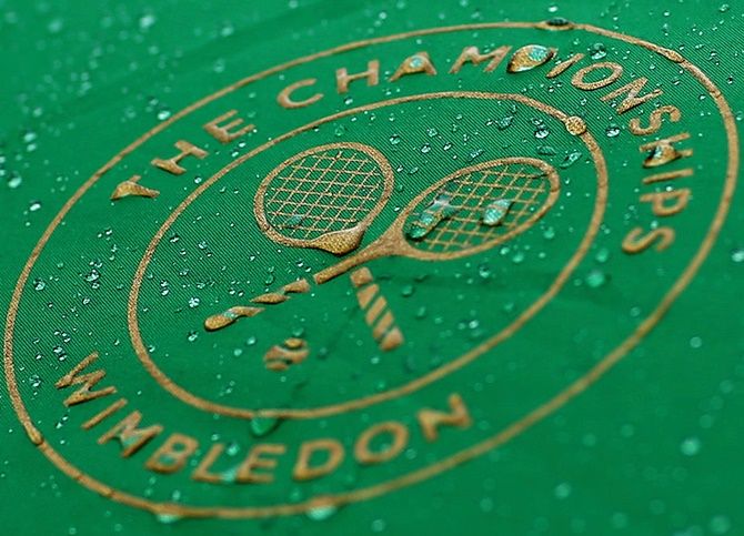 Raindrops are seen on the Wimbledon logo