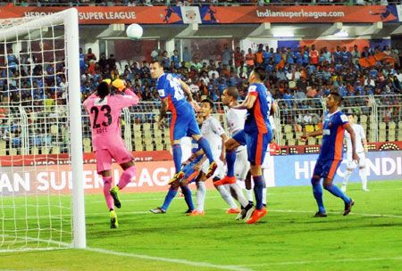 Players of FC Goa & Fc Pune City vie for the ball during their ISL match in Margao, Goa on Saturday.