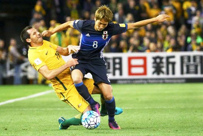 Japan's Genki Haraguchi and Australia's Ryan McGowan vie for possession during their 2018 FIFA World Cup qualifier at Docklands stadium in Melbourne on Tuesday