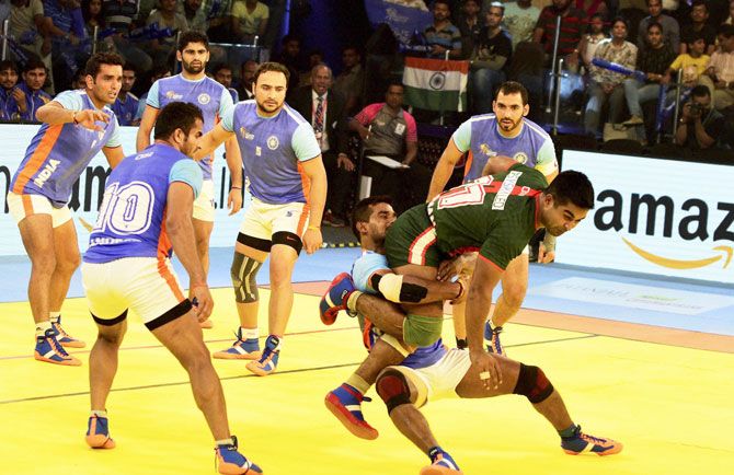 Indian players try to catch player from Bangladesh during their Kabaddi World Cup 2016 match in Ahmedabad on Tuesday