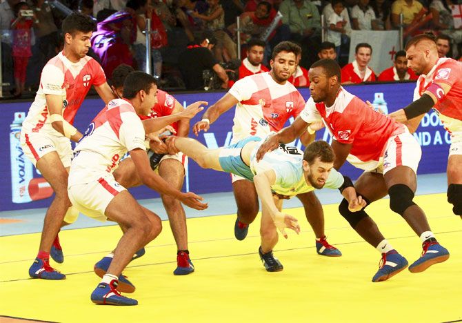 England players try to catch a player of Argentina during Kabaddi World Cup match in Ahmedabad on Friday