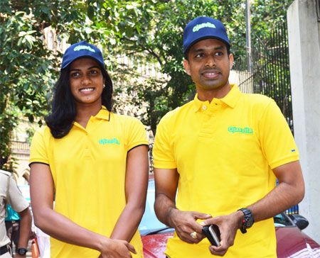 Rio Olympics silver medallist P V Sindhu with coach Pullela Gopichand at the launch of Sri Sri Ayurveda's Ojasvita range of products on Friday