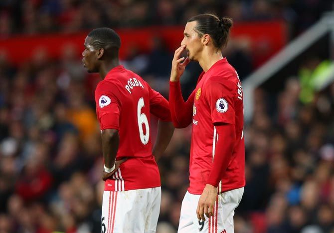 Paul Pogba, left, and Zlatan Ibrahimovic of Manchester United react