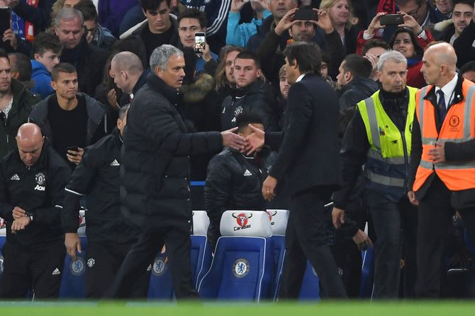Manager of Chelsea Antonio Conte (right) is congratulated by Manager of Manchester United Jose Mourinho after the full time whistle