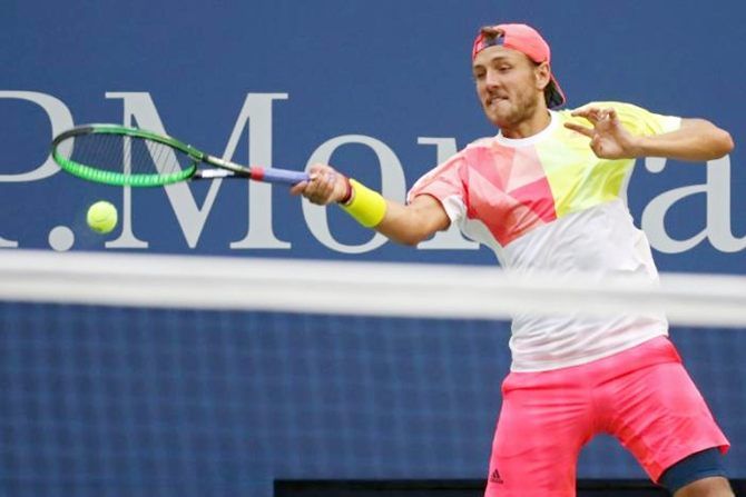 Lucas Pouille of France hits a forehand against Spain's Rafael Nadal of Spain