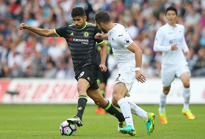 Swansea City's Jordi Amat (right) battles for the ball with Chelsea's Diego Costa during the Premier League match at Liberty Stadium in Swansea on Sunday