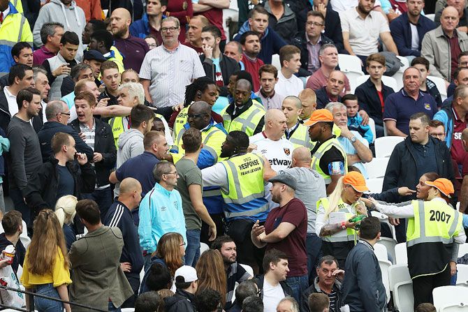 West Ham United fans and Watford fans clash during the English Premier League match at Olympic Stadium in London on Saturday