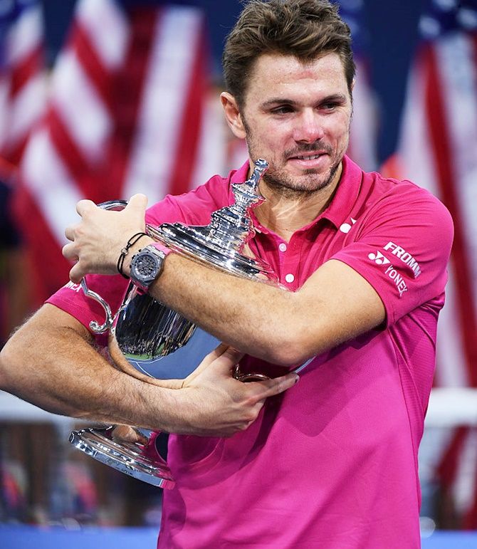  Stanislas Wawrinka of Switzerland celebrates with the trophy after defeating Novak Djokovic of Serbia at the US Open on September 11, 2016