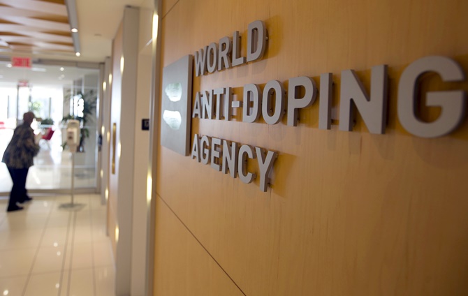 A woman walks into the head office of the World Anti-Doping Agency in Montreal