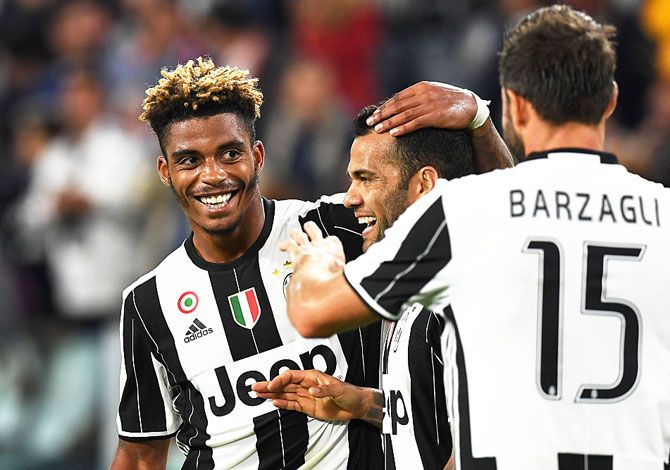 Juventus FC's Mario Lemina (left) of celebrates a goal with teammate Dan Alves during the Serie A match against Cagliari Calcio at Juventus Stadium in Turin on Wednesday