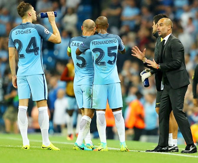 Manchester City manager Pep Guardiola issues instructions to his players