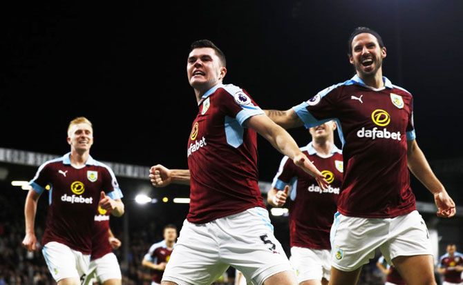 Burnley's Michael Keane celebrates with teammates after scoring their second goal against Watford