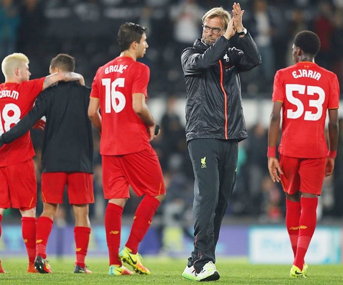 Jurgen Klopp, Manager of Liverpool waves to supporters