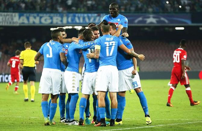 Napoli's Arkadiusz Milik celebrates with teammates after scoring against Benfica at the San Paolo Stadium, Naples, Italy, on Wednesday