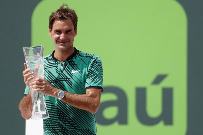 Switzerland's Roger Federer holds the Butch Buchholz trophy after beating Spain's Rafael Nadal to win the Miami Open title at Crandon Park Tennis Center in Key Biscayne, Florida, on Sunday