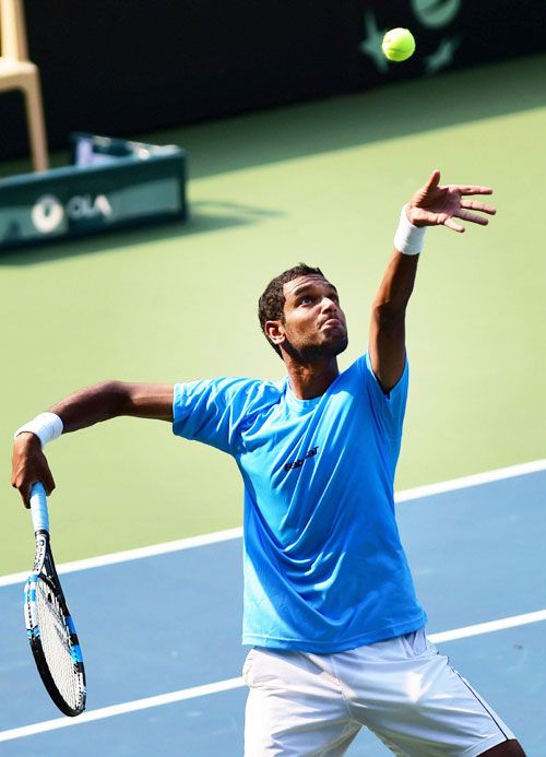India's Ramkumar Ramnathan serves against Uzbekistan's Sanjar Fayziev during the first reverse singles match of Asia Oceania Group 1 tie in Bengaluru on Sunday