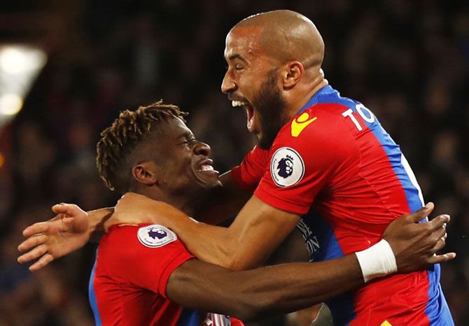 Crystal Palace's Andros Townsend celebrates with Wilfried Zaha after scoring the opening goal against Arsenal during their English Premier League match at Selhurst Park on Monday