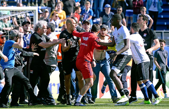 A scuffle ensues as a Bastia fan attacks Lyon goalkeeper Anthony Lopes on Sunday