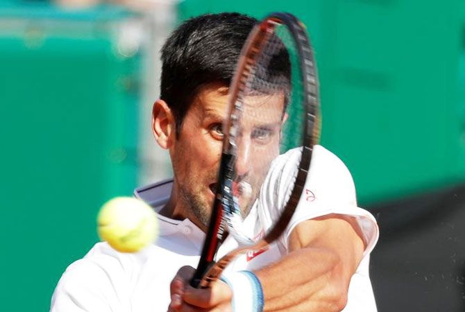 Novak Djokovic plays a return during his match against David Goffin