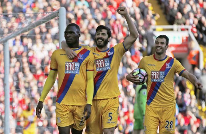 Crystal Palace's Christian Benteke (left) celebrates scoring the club's second goal with teammates during their English Premier League match against Liverpool at Anfield on Sunday