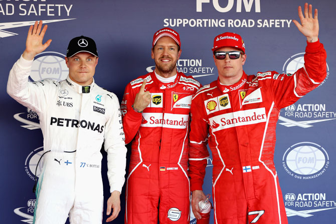 Ferrari's Sebastian Vettel (centre) and Kimi Raikkonen (right) and Mercedes GP's Valtteri Bottas in parc ferme after qualifying for the Formula One Grand Prix of Russia in Sochi on Saturday