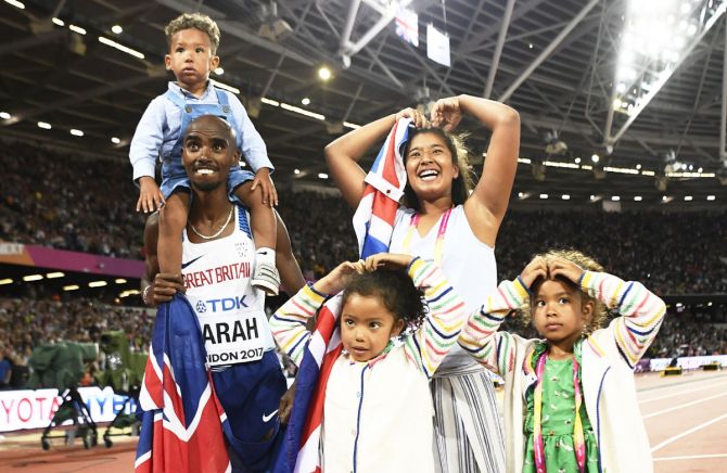 Mo Farah of Britain celebrates with his children after winning the race