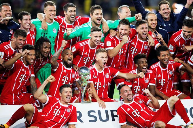 Bayern Munich players celebrate with the trophy after winning the DFL-Supercup Final