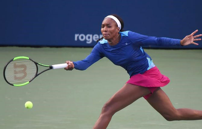 Venus Williams of the United States plays a shot against Irina-Camelia Begu of Romania during the Rogers Cup tennis tournament at Aviva Centre in Toronto, Ontario on Monday
