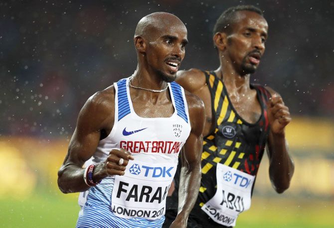 Mo Farah (left) and of Britain and Bashir Abdi of Belgium compete in the 5000m heats at the World Athletics Championships in London on Wednesday