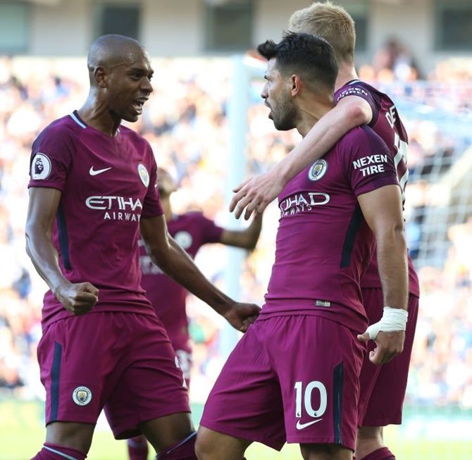 Manchester City’s Sergio Aguero, right, celebrates with teammates