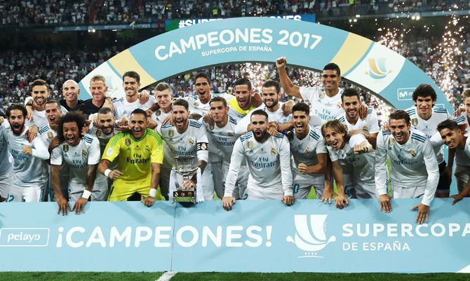 Real Madrid players celebrate with the trophy after winning the Spanish Super Cup against Barcelona in Madrid on Wednesday
