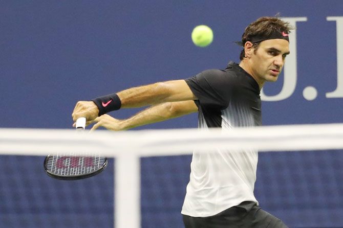 Roger Federer plays a backhand return during his first round match against Frances Tiafoe on Tuesday
