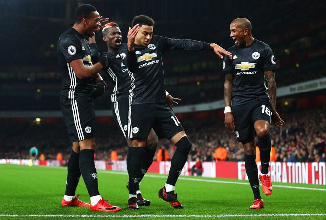 Manchester United's Jesse Lingard breaks into a jig as celebrates with teammates after scoring his side's second goal against Arsenal during their match at the Emirates Stadium in London on Saturday