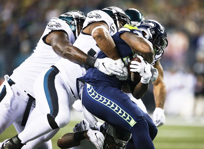 Running back Mike Davis #39 of the Seattle Seahawks drags several Philadelphia Eagles players with him during a rush in the first quarter at CenturyLink Field in Seattle, Washington, on Sunday