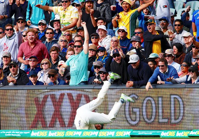 The crowd reacts as England's Dawid Malan fails to stop a boundary during the first day of the second Ashes cricket Test match at Adelaide Oval in Adelaide on Saturday