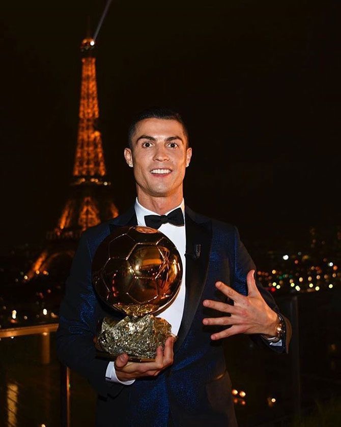 Cristiano Ronaldo poses with the Ballon d'Or award on Thursday