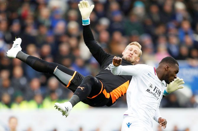 Crystal Palace's Christian Benteke fouls Leicester City's Kasper Schmeichel (left)