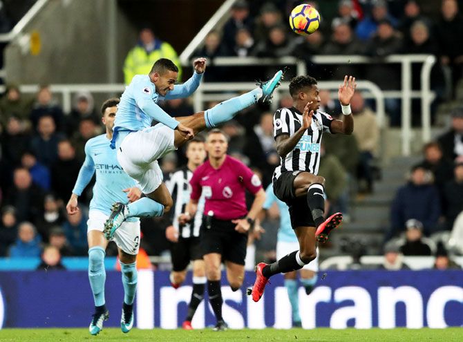 Manchester City's Danilo goes flying as he vies for possession with Newcastle United's Rolando Aarons
