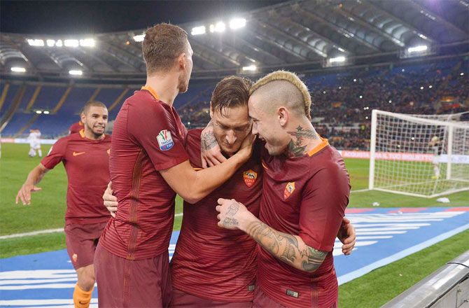 AS Roma's Francesco Totti celebrates with teammates after scoring against Cesena during their Coppa Italia match quarter-final on Wednesday