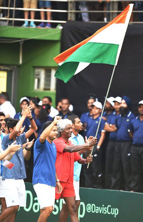 India's team captain Anand Amritraj does a lap of honour with the Indian flag alongside his teammates on Sunday