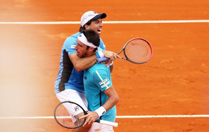 Argentina's Carlos Berlocq and Leonardo Mayer celebrate after winning their doubles match against Italy's Fabio Fognini and Simone Bolelli in the Davis Cup World Group First Round tie at Parque Sarmiento stadium in Buenos Aires, Argentina, on Saturday