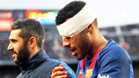 FC Barcelona's Rafinha has his face covered in bandage by the medical staff on Saturday
