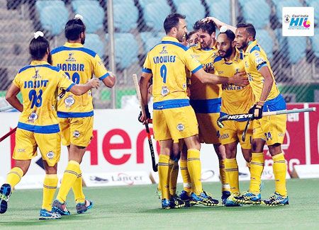 Punjab Warriors players celebrate a goal against Delhi Waveriders during their HIL match on Tuesday