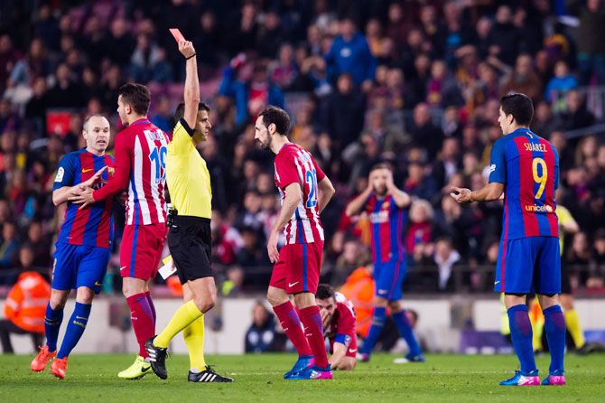 Luis Suarez (right) is given marching orders by referee Jesus Gil Manzano during their Copa del Rey semi-final second leg match against Atletico de Madrid at Camp Nou in Barcelona on Tuesday