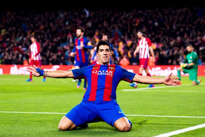 FC Barcelona's Luis Suarez celebrates after scoring the opening goal during their Copa del Rey semi-final second leg match against Atletico de Madrid at Camp Nou in Barcelona on Tuesday